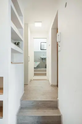 a hallway of a house with white walls and wooden floors at Central Studio Apartment with Parking - Near Main Train Station & Wenceslas Square in Prague