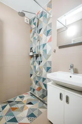 a bathroom with a sink and a mosaic tile floor at Central Studio Apartment with Parking - Near Main Train Station & Wenceslas Square in Prague