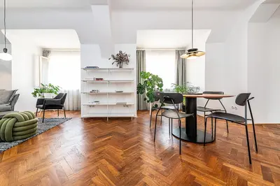 a living room with a table and chairs at Central Apartment with breathtaking view in Prague