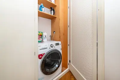 a washer and dryer in a small room at Central Apartment with breathtaking view in Prague