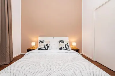 a bedroom with a large white bed with two lamps at Stunning 2 bed in prime central location in Prague