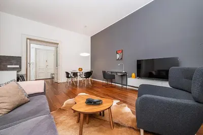 a living room with a couch and a table at Stunning 2 bed in prime central location in Prague