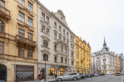 a row of buildings on a street with parked cars at Stunning 2 bed in prime central location in Prague