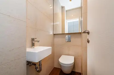 a bathroom with a toilet and a sink and a mirror at Stunning 2 bed in prime central location in Prague