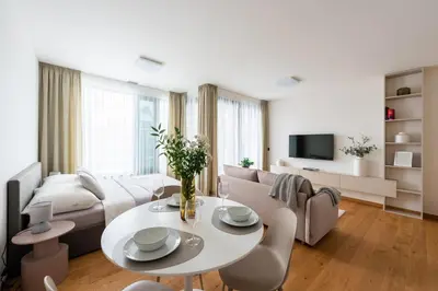 a living room with a couch and a table at Prague Modern Apartment in Prague