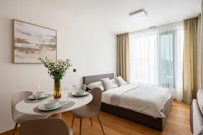 a bedroom with a bed and a table and chairs at Prague Modern Apartment in Prague