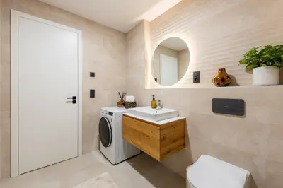 a bathroom with a washing machine and a sink at Prague Modern Apartment in Prague