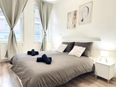 a bedroom with a large bed with two pillows on it at Peaceful Apartment near City in Prague