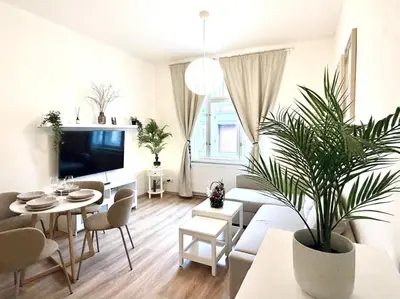 a living room with a couch and a table with a plant at Peaceful Apartment near City in Prague
