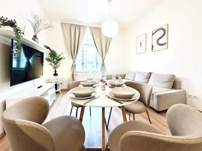 a living room with a table and chairs and a couch at Peaceful Apartment near City in Prague