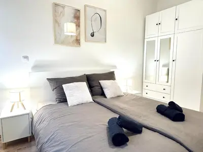 a bedroom with a large bed with two pillows at Peaceful Apartment near City in Prague