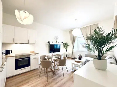 a kitchen and living room with a table and chairs at Peaceful Apartment near City in Prague