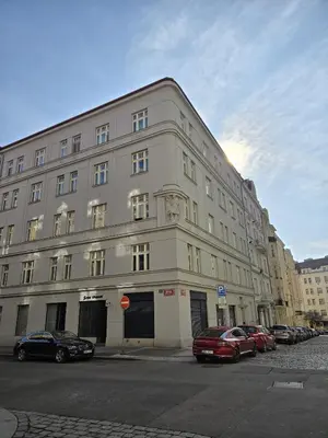 a large white building with cars parked in front of it at Peaceful Apartment near City in Prague