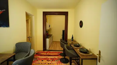 a living room with a dining room table and chairs at Spacious 2 Bedroom Apartment in Prague 2 in Prague