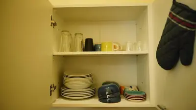 a cabinet filled with plates and cups and dishes at Spacious 2 Bedroom Apartment in Prague 2 in Prague