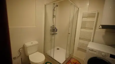 a bathroom with a toilet and a glass shower at Spacious 2 Bedroom Apartment in Prague 2 in Prague