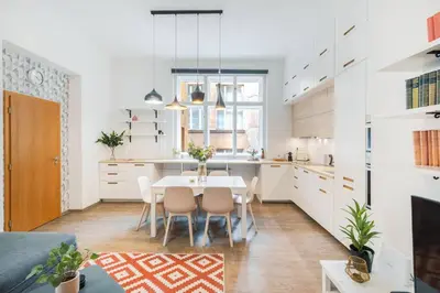 a white kitchen with a table and chairs at Central 2 Bedrooms Apartment with Living Room & Parking - Near Wenceslas Square & Main Train Station in Prague