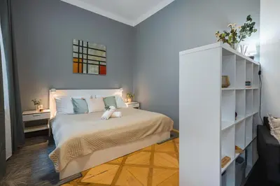 a bedroom with a bed with a teddy bear on it at Central 2 Bedrooms Apartment with Living Room & Parking - Near Wenceslas Square & Main Train Station in Prague