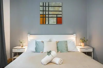 a bedroom with a white bed with two night stands at Central 2 Bedrooms Apartment with Living Room & Parking - Near Wenceslas Square & Main Train Station in Prague