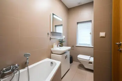 a bathroom with a sink and a toilet and a tub at Central 2 Bedrooms Apartment with Living Room & Parking - Near Wenceslas Square & Main Train Station in Prague