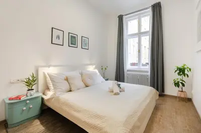 a bedroom with a bed with a teddy bear on it at Central 2 Bedrooms Apartment with Living Room & Parking - Near Wenceslas Square & Main Train Station in Prague