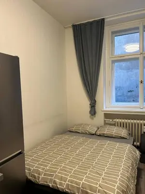 a bedroom with a bed in front of a window at Urban Chic Apartment Prague 1 in Prague