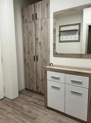 a bathroom with a dresser and a wooden cabinet at Urban Chic Apartment Prague 1 in Prague