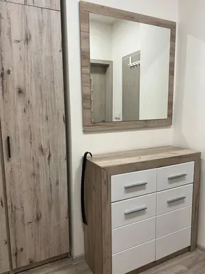 a bathroom with a wooden dresser and a mirror at Urban Chic Apartment Prague 1 in Prague