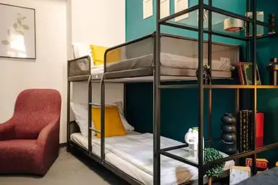 a room with two bunk beds and a red chair at Spacious 3BR Apartment with Billiards & Cinema in Prague