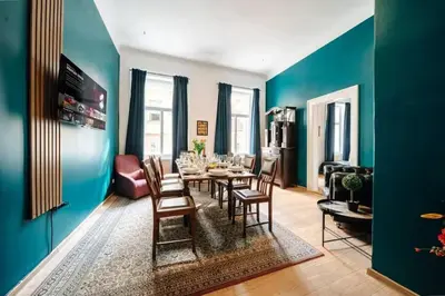 a dining room with a table and chairs at Spacious 3BR Apartment with Billiards & Cinema in Prague