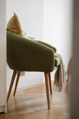 a green chair sitting on a wooden floor at Sudomerská 5, Zizkov, Czech Republic in Prague