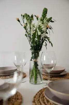 a vase of flowers sitting on a table with glasses at Sudomerská 5, Zizkov, Czech Republic in Prague