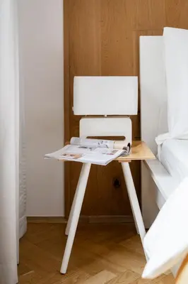a desk with a computer on it next to a bed at Sudomerská 5, Zizkov, Czech Republic in Prague