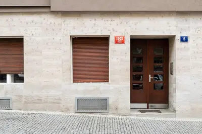 a building with two brown doors and a building at Sudomerská 5, Zizkov, Czech Republic in Prague