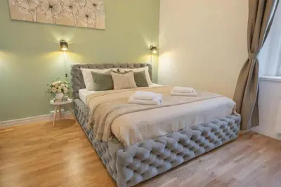 a bedroom with a large bed with two towels on it at HOMELY I BIG Central APTI ELEVATOR I Self Check-In in Prague