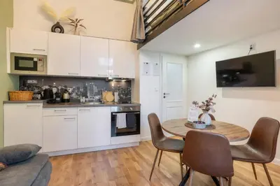 a living room with a couch and a table at HOMELY I BIG Central APTI ELEVATOR I Self Check-In in Prague