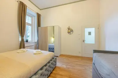 a bedroom with a bed with towels on it at HOMELY I BIG Central APTI ELEVATOR I Self Check-In in Prague