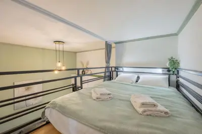 a bedroom with a large bed and a window at HOMELY I BIG Central APTI ELEVATOR I Self Check-In in Prague