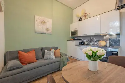 a kitchen and living room with a table and chairs at HOMELY I BIG Central APTI ELEVATOR I Self Check-In in Prague