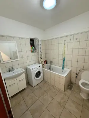 a bathroom with a sink and a washing machine in it at Ubytování Mladá Boleslav in Mladá Boleslav