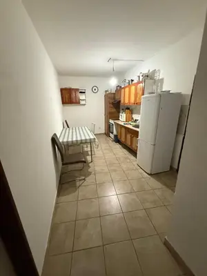 a kitchen with a table and a white refrigerator at Ubytování Mladá Boleslav in Mladá Boleslav
