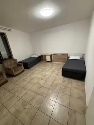 a room with two beds and a chair in it at Ubytování Mladá Boleslav in Mladá Boleslav