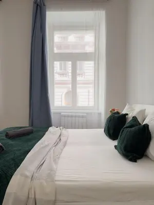 a large white bed in a room with a window at REAL Living by REFA - New Town 210 in Prague