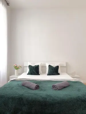 a bedroom with a large bed with two pillows on it at REAL Living by REFA - New Town 210 in Prague