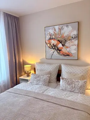 a bedroom with a bed and a painting on the wall at My Sweet Home - Makedonská - Prague in Prague