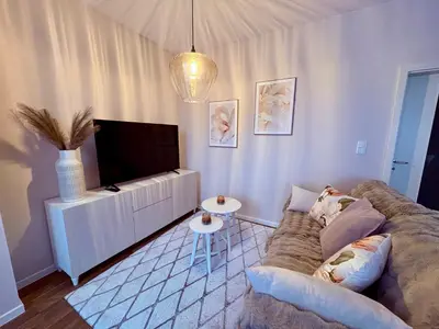 a living room with a couch and a flat screen tv at My Sweet Home - Makedonská - Prague in Prague