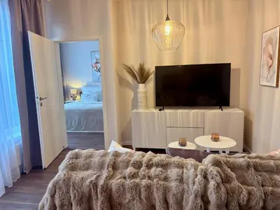 a living room with a couch and a flat screen tv at My Sweet Home - Makedonská - Prague in Prague