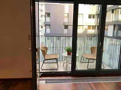 a balcony with chairs and a table and a building at Fortuna Garden III in Prague