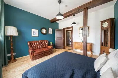 a bedroom with a bed and a clock on the wall at Castle Charm Apartments by Wagnerstays in Prague