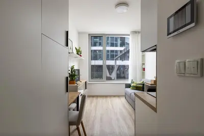 a living room with a couch and a table at Modern Apartment Near Anděl & Metro in Prague